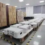 Bulk stock of 5kWh stackable battery storage units ready for global DDP shipping.