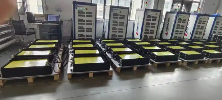 Rack mount LiFePO4 batteries connected to equipment for rigorous aging and capacity testing in the factory.